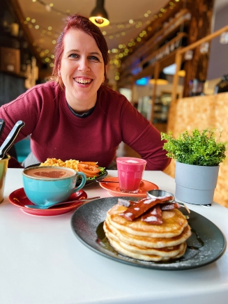 Woman with a plate of delicious food at Greenwood Cafe